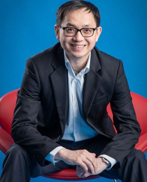 Singapore professional photography of a business leader seating in a red chair, image by Tuckys Photography