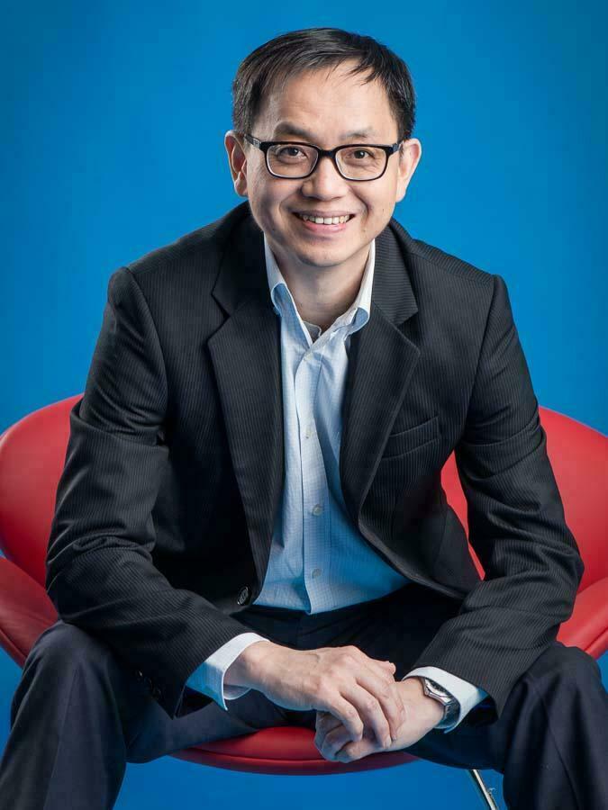 Singapore professional photography of a business leader seating in a red chair, image by Tuckys Photography