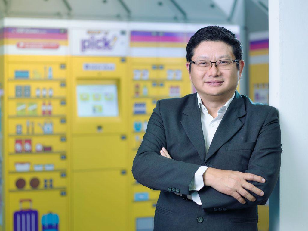 Professional business headshot of Pick Network Pte Ltd CEO in front of their company lockers. Studio photoshoot with professional lighting on location.