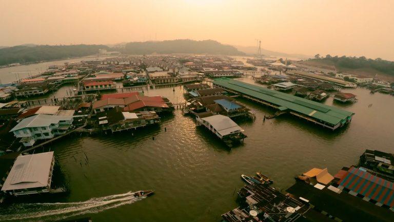 Kampong Ayer water village in Brunei at dusk from the air, stilt houses and jetties on the Brunei River