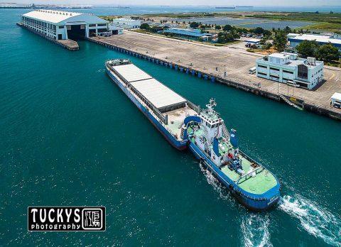 aerial photography for marine tug boat and barge. architecture photography of building, by tuckys