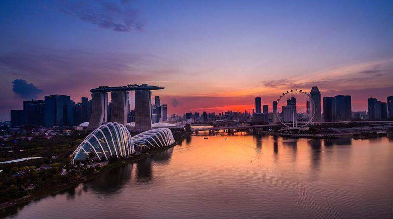 A dramatic sunset with Singapore aerial photography at the city skyline ...