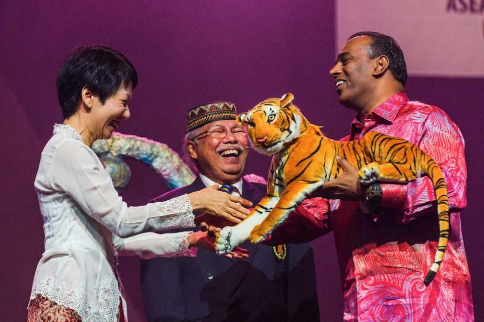 Handing over ceremony from Singapore to Malaysia. Critical moments showing the joyous occasion during the the presentation of the Malaysia Mascot as a commemorative token of appreciation between the 2 minister of each countries is captured by corporate events photographer