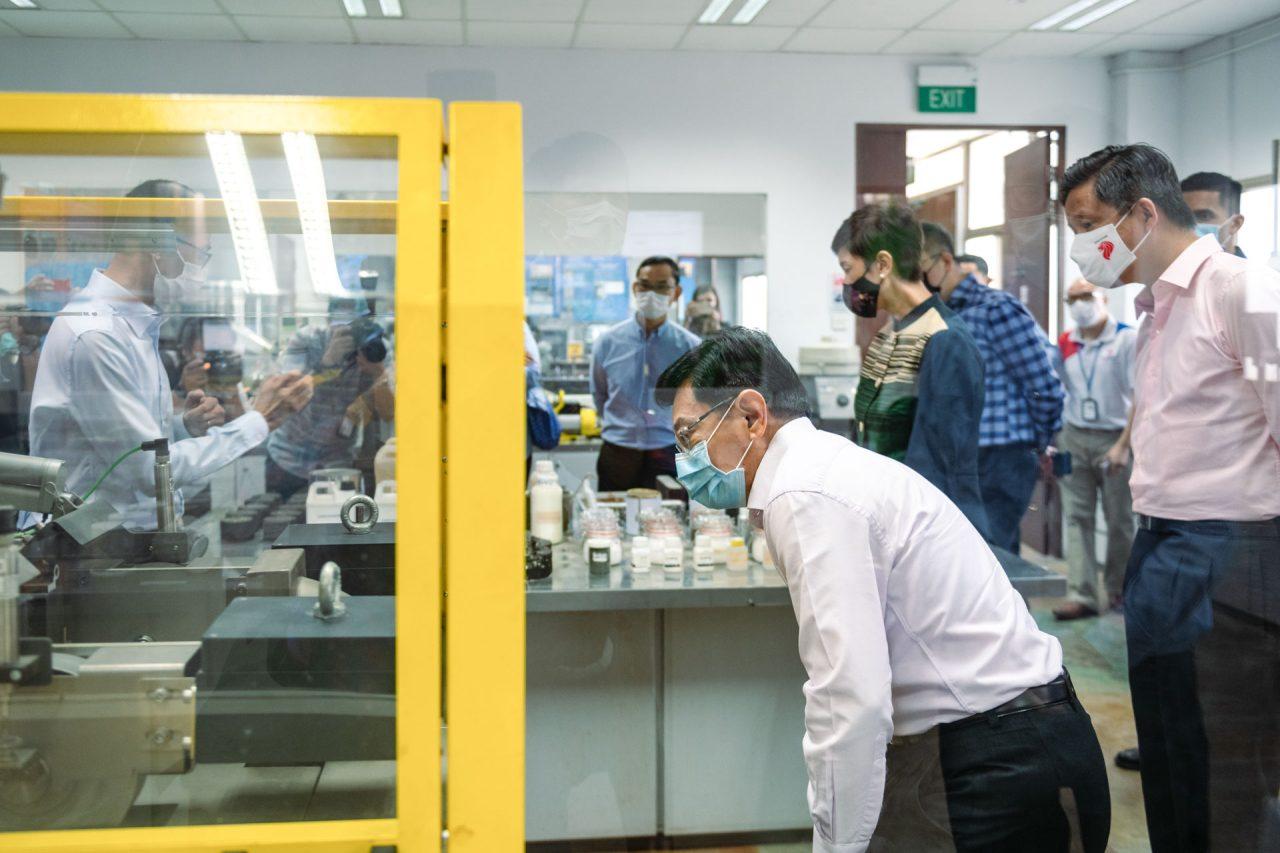 corporate events photography showing Minister checking out the testing machine.