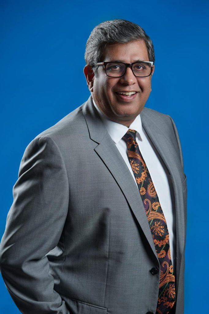Corporate headshot of Alok Ohrie, President and Managing Director of Dell Technologies India, against a blue backdrop. Corporate Studio portrait for Dell technologies during Singapore MICE