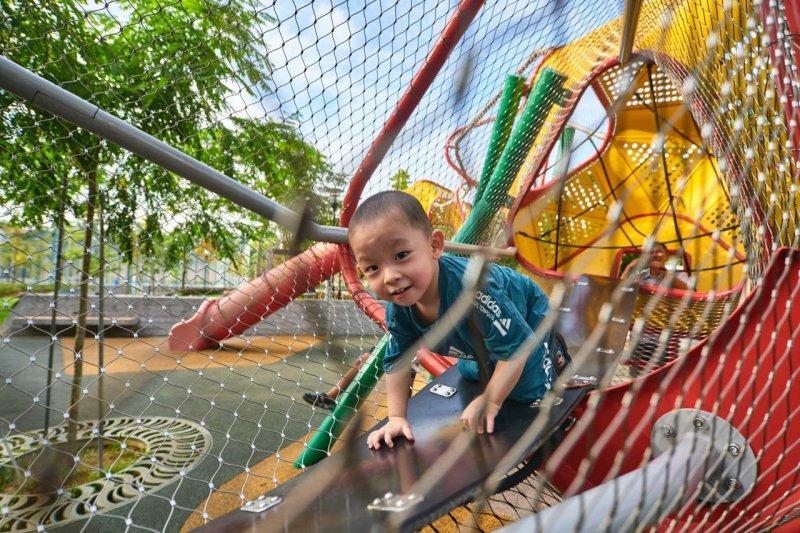 Bespoke Playground 10 Young boy playing in a colorful netted playground, representing lifestyle architecture photography. Blending Play & Design: The Essence of Lifestyle Architecture Photography