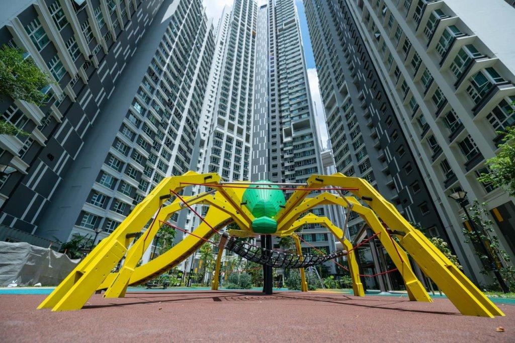 Bespoke Playground architectural photography for Singapore playground Photography. Bespoke Playground architectural photography for Singapore playground Photography. Modern playground equipment with vibrant yellow and green accents, nestled between towering residential buildings