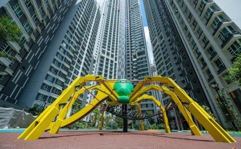 Bespoke Playground architectural photography for Singapore playground Photography. Modern playground equipment with vibrant yellow and green accents, nestled between towering residential buildings