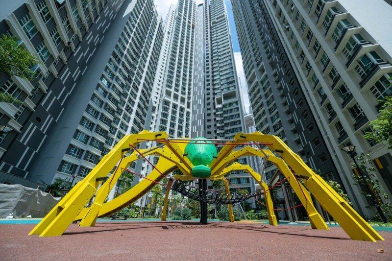 Bespoke Playground 2 Bespoke Playground architectural photography for Singapore playground Photography. Modern playground equipment with vibrant yellow and green accents, nestled between towering residential buildings