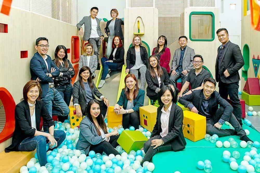 candid corporate group portraiture in a indoor playground. — professional portrait photographer singapore, portrait photography singapore