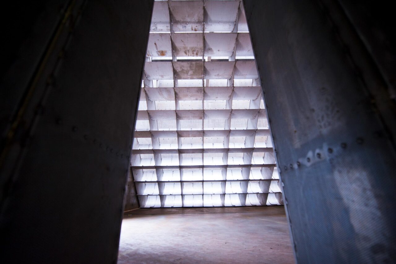 Looking through the acoustic splitter panels of the Rolls-Royce Seletar engine test cell towards the backlit intake wall