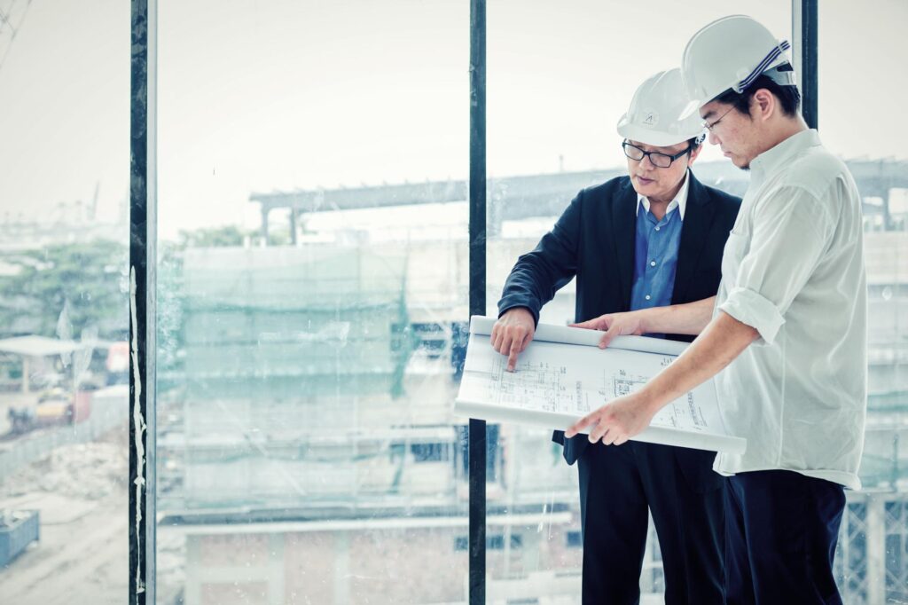 A site team reviewing drawings during a project walkthrough. Industrial photography in Singapore.