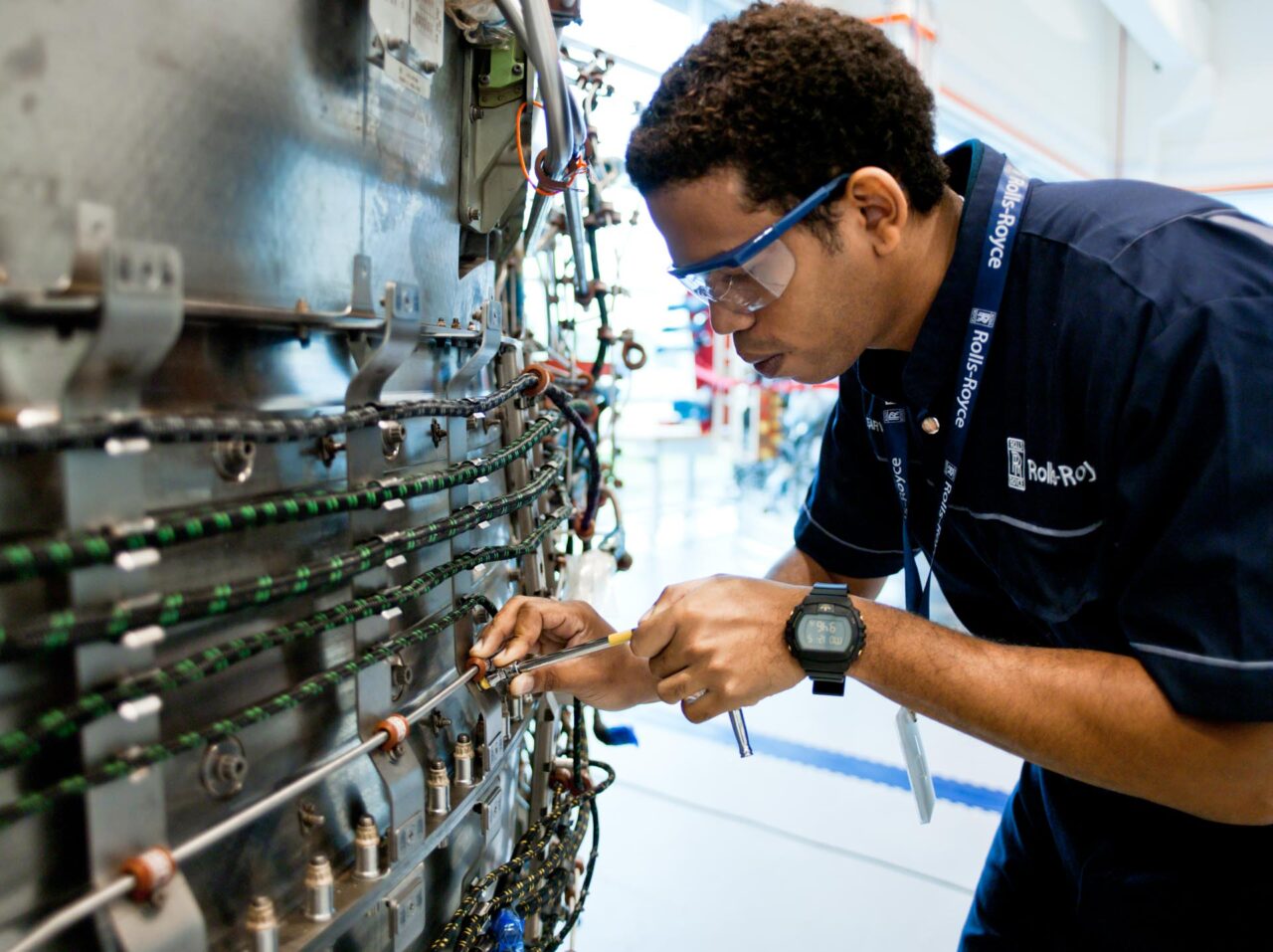 An aerospace technician instrumenting an engine component. Aviation and aerospace photography in Singapore.
