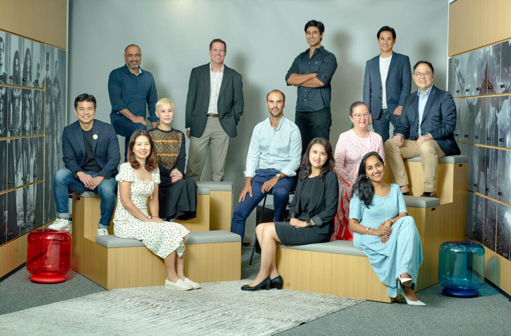 Warner Bros. Discovery leadership team in a relaxed group portrait in their Singapore office — classic corporate portrait singapore, studio portrait photographer singapore