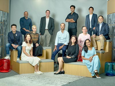 Warner Bros. Discovery leadership team in a relaxed group portrait in their Singapore office — classic corporate portrait singapore, studio portrait photographer singapore