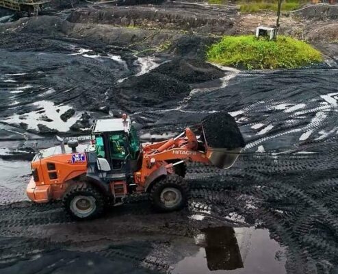 Hitachi ZW220 wheel loader on a wet coal stockpile, industrial photography and videography